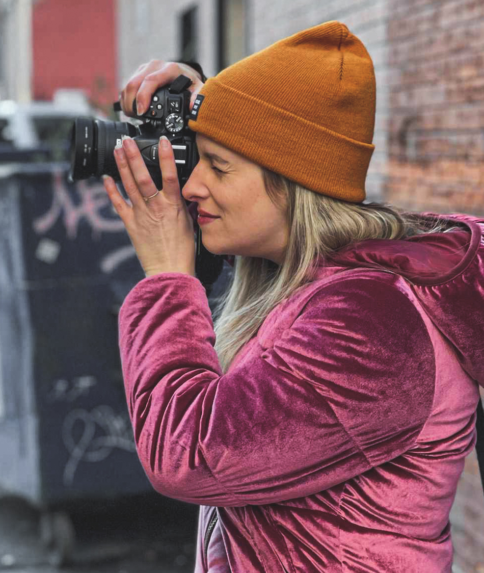 Photograph of me taking a photo in an alley with my DSLR, looking to the left